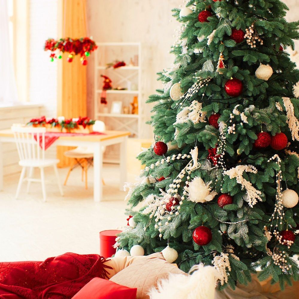 winter-holidays-decor-rich-decorated-new-year-tree-stands-with-present-boxes.jpg